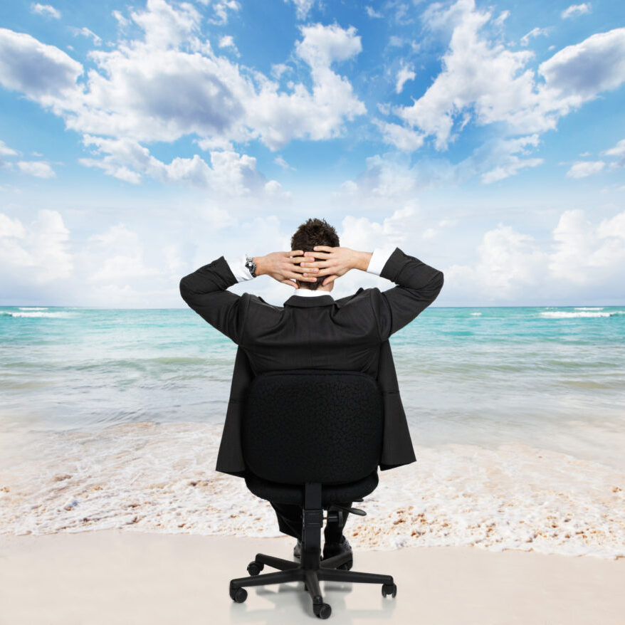 Young businessman relaxing on the beach. Conceptual background.